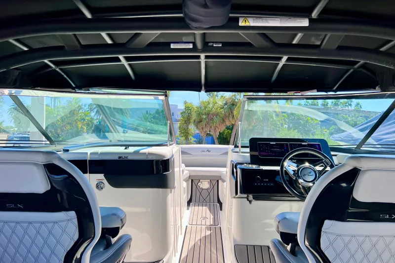 Slide: The Image of 2024 Sea Ray SLX 260 Outboard interior with modern dashboard and seating. - 73