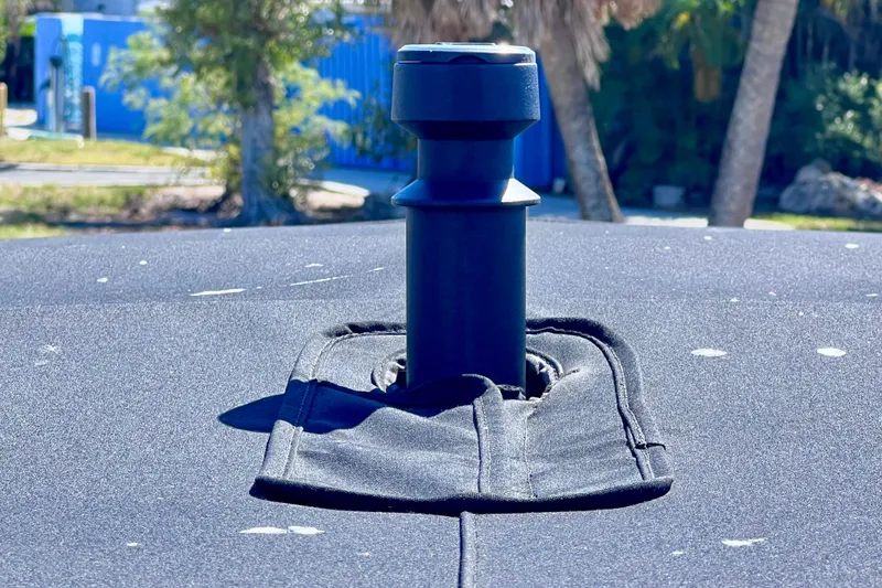 Slide: The Image of 2024 Sea Ray SLX 260 Outboard boat detail with a black fabric cover and pole. - 75