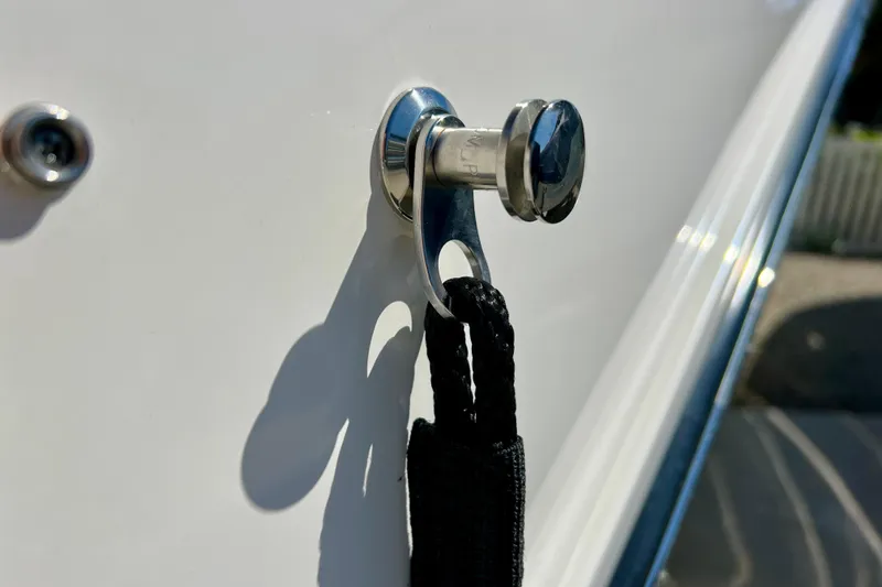 Slide: The Image of Close-up of a 2024 Sea Ray SLX 260 Outboard boat cleat with attached rope. - 76