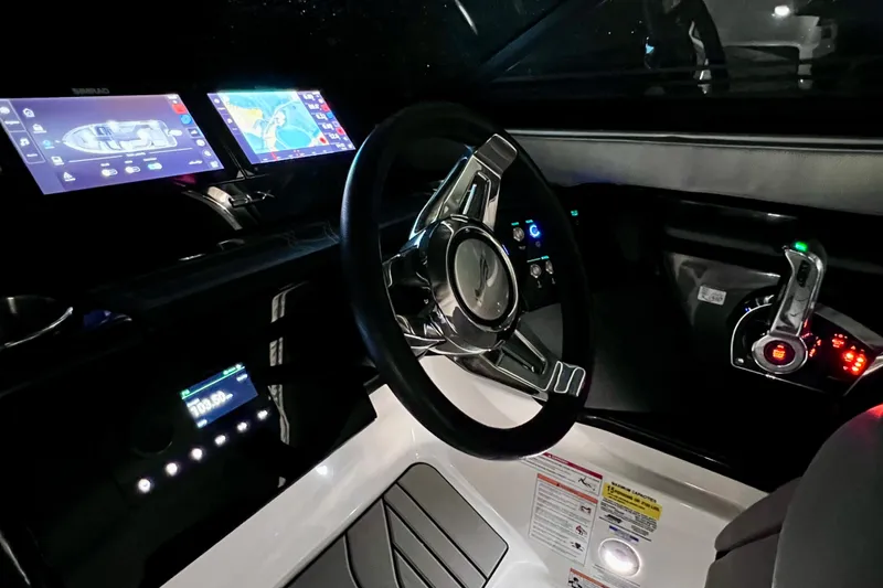 Slide: The Image of 2024 Sea Ray SLX 260 Outboard dashboard with modern controls and digital displays. - 77