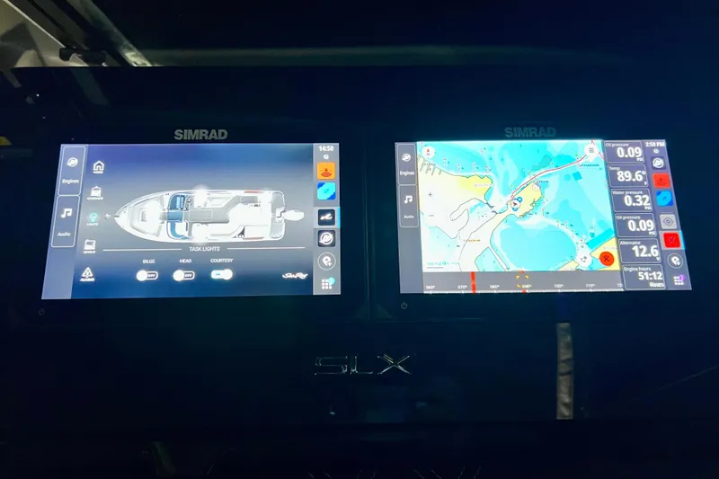 Slide: The Image of Simrad navigation screens on 2024 Sea Ray SLX 260 Outboard boat dashboard. - 79