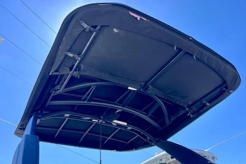 Slide: The Image of 2024 Sea Ray SLX 260 Outboard boat canopy against clear blue sky. - 8