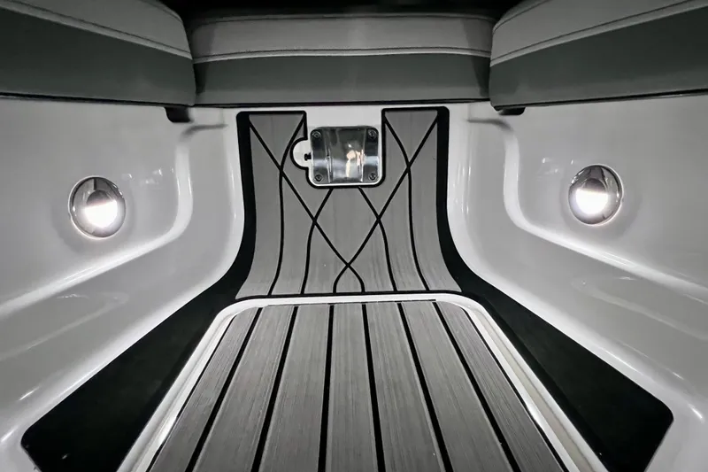 Slide: The Image of 2024 Sea Ray SLX 260 Outboard interior with sleek flooring and ambient lighting. - 81