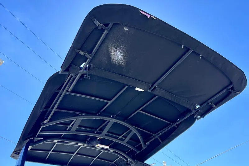 Slide: The Image of 2024 Sea Ray SLX 260 Outboard boat canopy against clear blue sky. - 9