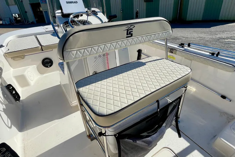Slide: The Image of 2021 Carolina Skiff 17 LS boat interior with cushioned seating and steering console. - 16