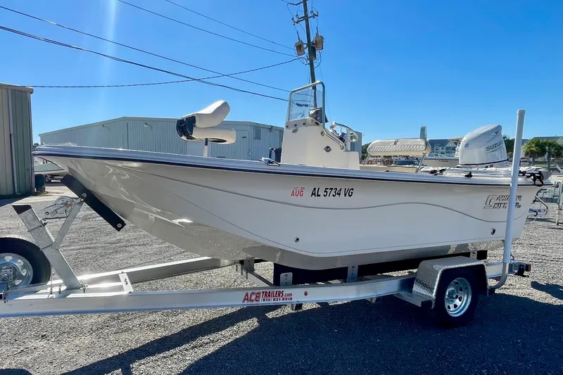 Slide: The Image of 2021 Carolina Skiff 17 LS boat on trailer, parked outdoors under clear blue sky. - 3