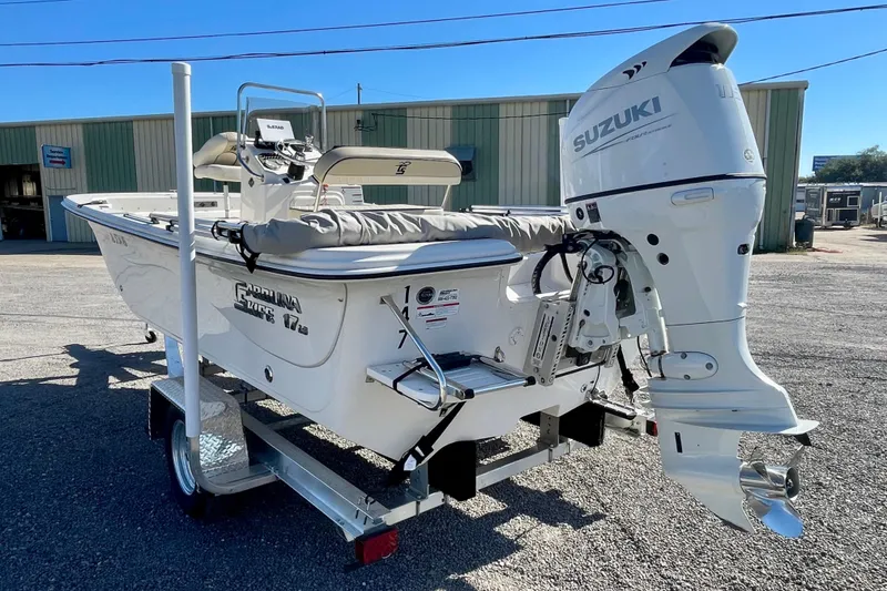 Slide: The Image of 2021 Carolina Skiff 17 LS boat with Suzuki outboard motor on a trailer. - 4