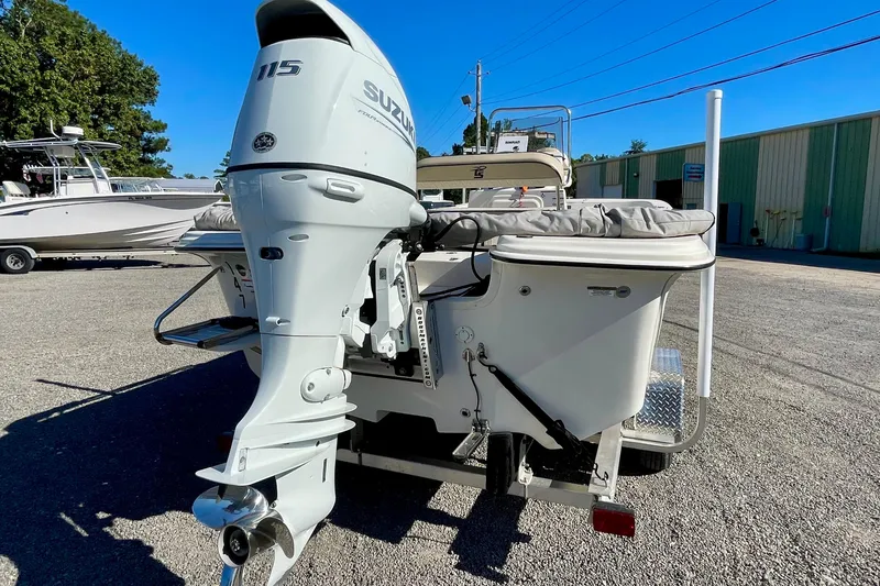 Slide: The Image of 2021 Carolina Skiff 17 LS boat with Suzuki 115 outboard motor, parked outdoors. - 5