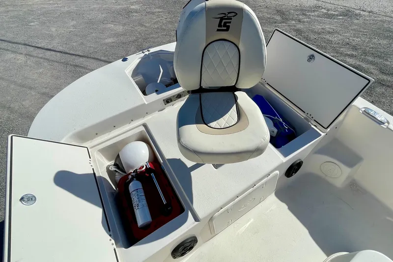 Slide: The Image of 2021 Carolina Skiff 17 LS boat interior with storage compartments and cushioned seat. - 9