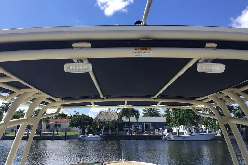 Slide: The Image of 2016 Chris-Craft Calypso 26 boat canopy with waterfront view. - 10