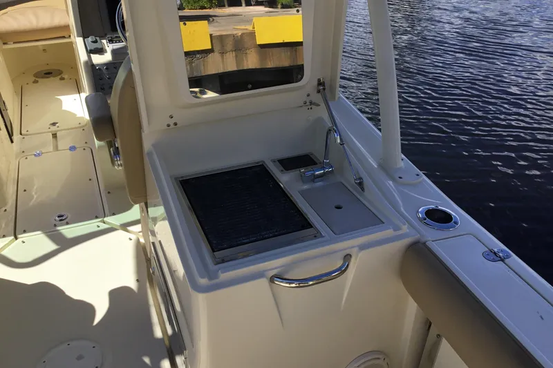 Slide: The Image of 2016 Chris-Craft Calypso 26 boat interior with sink and seating area. - 11