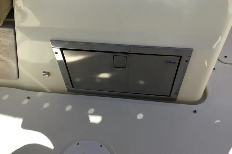 Slide: The Image of 2016 Chris-Craft Calypso 26 boat interior with stainless steel storage compartment. - 24