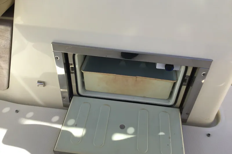 Slide: The Image of Storage compartment on a 2016 Chris-Craft Calypso 26 boat interior. - 25