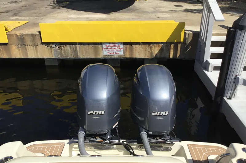 Slide: The Image of Twin Yamaha 200 engines on a 2016 Chris-Craft Calypso 26 at a dock. - 31