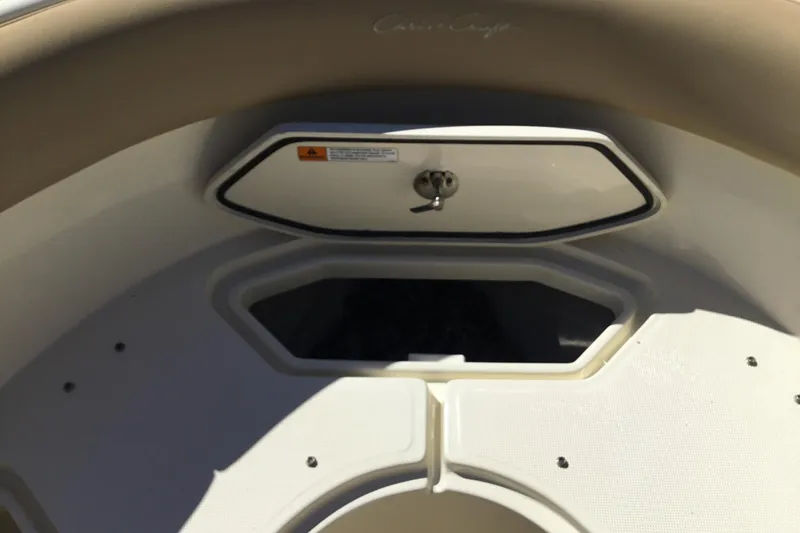 Slide: The Image of 2016 Chris-Craft Calypso 26 boat storage compartment with secure latch and beige interior. - 38