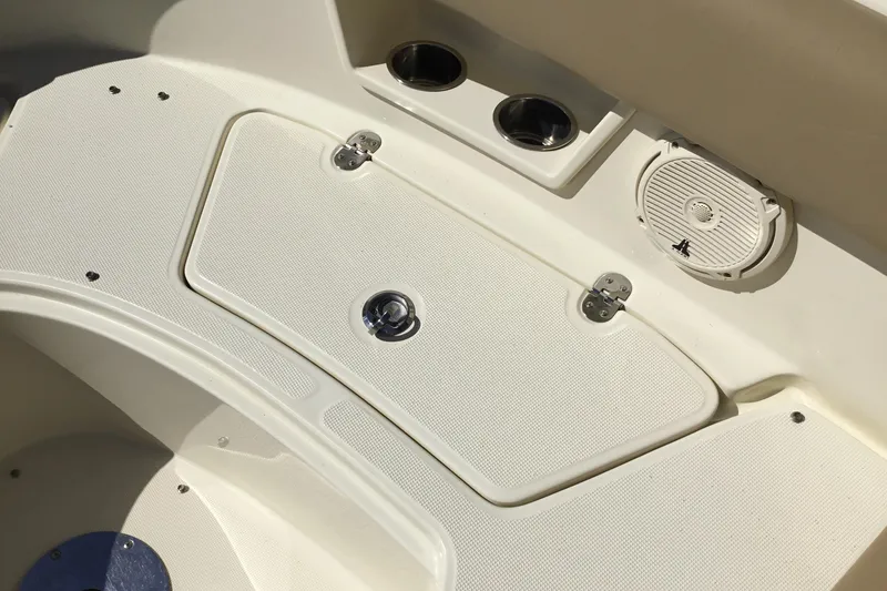 Slide: The Image of 2016 Chris-Craft Calypso 26 boat interior with storage compartment and speaker. - 39