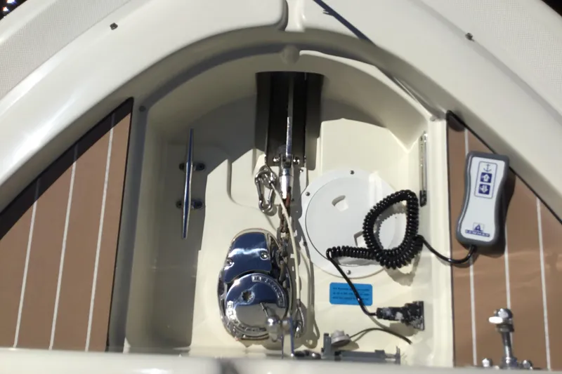 Slide: The Image of 2016 Chris-Craft Calypso 26 boat anchor compartment with control panel and chain. - 40