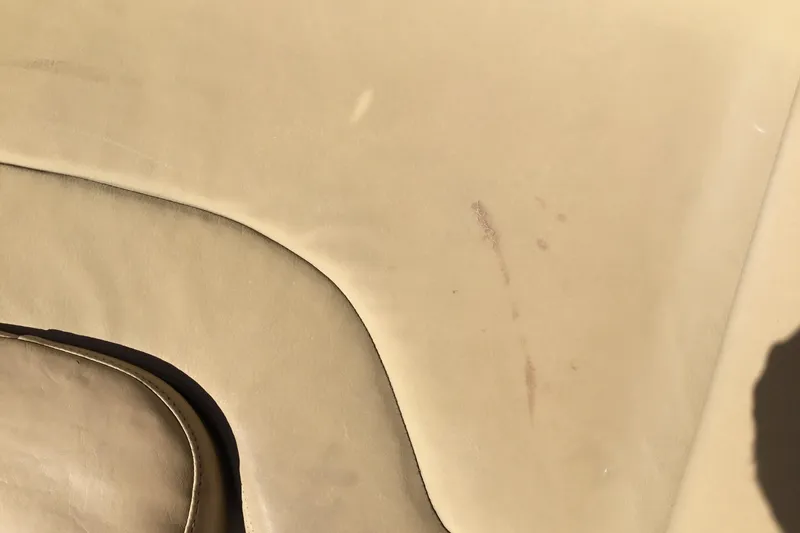 Slide: The Image of Worn beige upholstery on 2016 Chris-Craft Calypso 26 boat seat. - 44