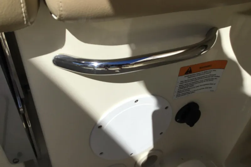 Slide: The Image of 2016 Chris-Craft Calypso 26 interior detail with chrome handle and warning label. - 46