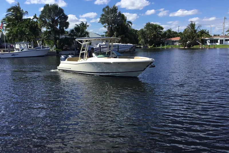 Slide: The Image of 2016 Chris-Craft Calypso 26 boat cruising on a sunny day in a scenic waterway. - 51