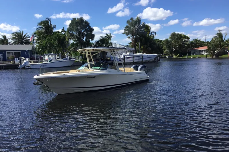 Slide: The Image of 2016 Chris-Craft Calypso 26 boat on a sunny day in a scenic marina. - 54