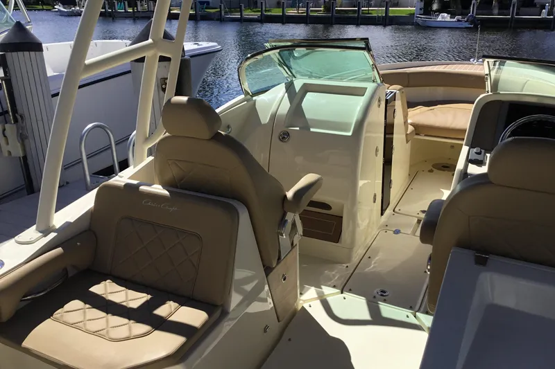 Slide: The Image of 2016 Chris-Craft Calypso 26 boat interior with tan seating and open deck. - 8