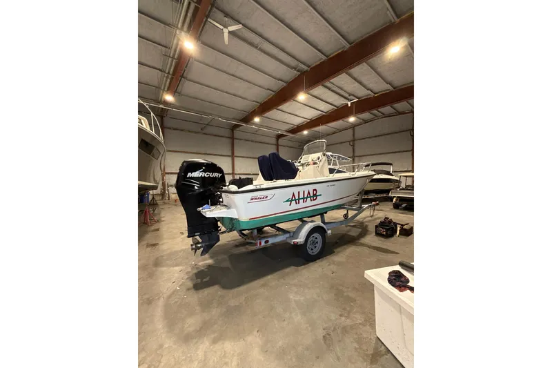 Slide: The Image of 2008 Boston Whaler 190 Outrage boat on trailer in indoor storage facility. - 0