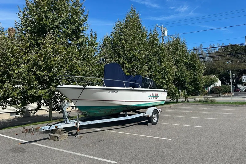 Slide: The Image of 2008 Boston Whaler 190 Outrage boat with Mercury engine in a warehouse. - 1