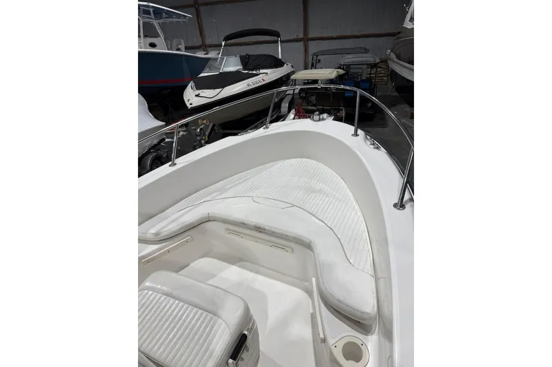 Slide: The Image of 2008 Boston Whaler 190 Outrage boat interior, featuring clean white deck and console details. - 10