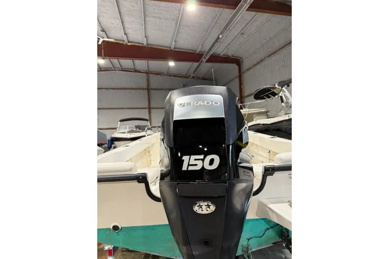 Slide: The Image of 2008 Boston Whaler 190 Outrage boat interior with seating and railing in storage. - 13