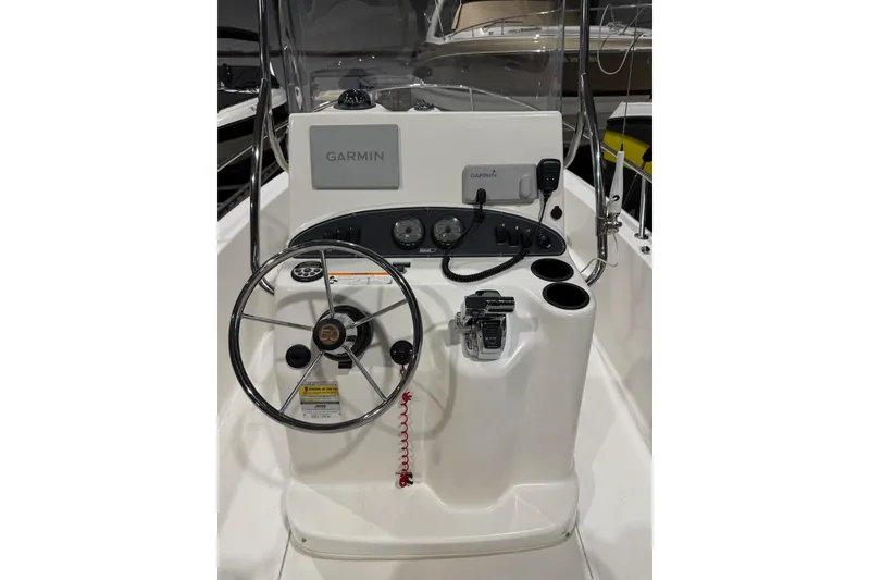 Slide: The Image of 2008 Boston Whaler 190 Outrage boat console with Garmin navigation system and steering wheel. - 4