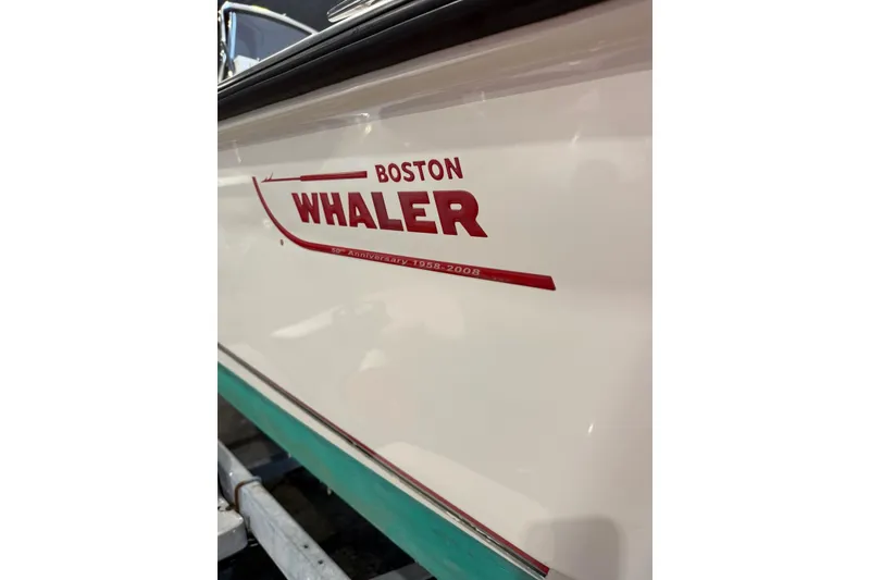 Slide: The Image of 2008 Boston Whaler 190 Outrage boat interior with white seating and storage. - 9