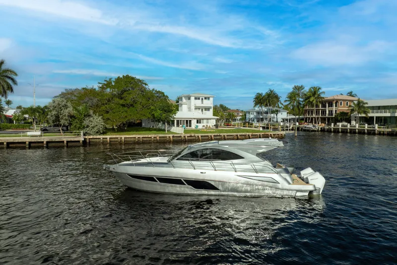 Slide: The Image of Luxury Valiatt 410HT yacht cruising near waterfront homes, 2025 model. - 25