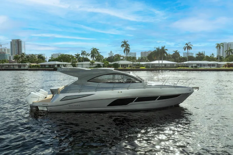 Slide: The Image of 2025 Valiatt 410HT luxury yacht on a scenic waterfront with palm trees and city skyline. - 29