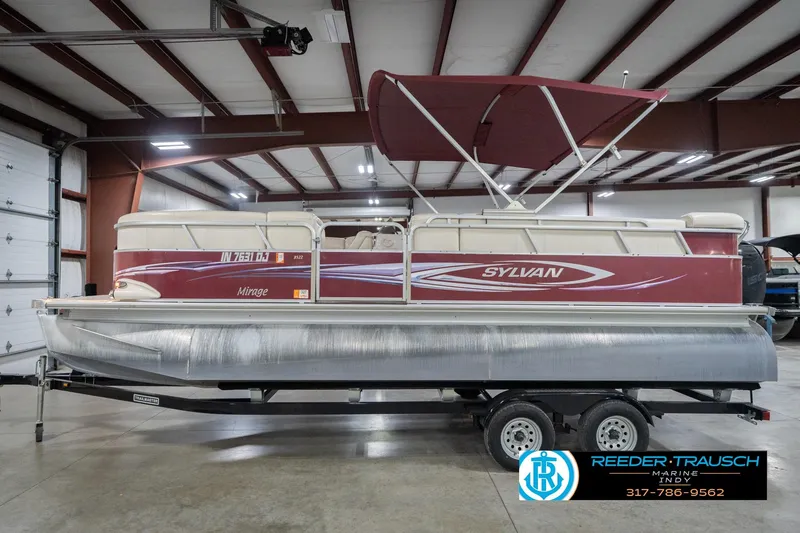 Slide: The Image of 2010 Sylvan 8522 Mirage Cruise pontoon boat in indoor storage on trailer. - 11