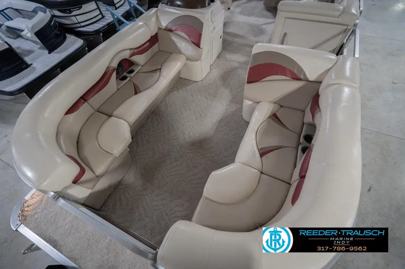 Slide: The Image of 2010 Sylvan 8522 Mirage Cruise boat interior with beige and red seating. - 12