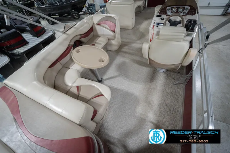Slide: The Image of Interior of 2010 Sylvan 8522 Mirage Cruise pontoon boat with plush seating and helm. - 14