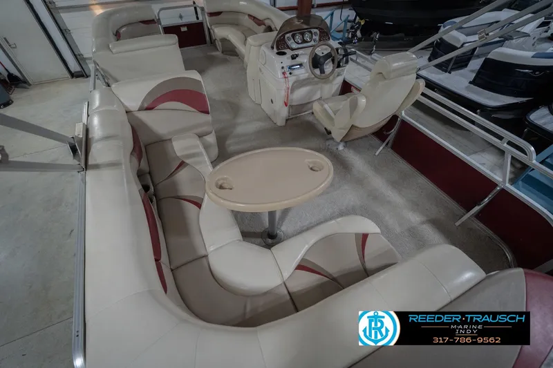 Slide: The Image of 2010 Sylvan 8522 Mirage Cruise pontoon boat interior with beige seating and steering console. - 15