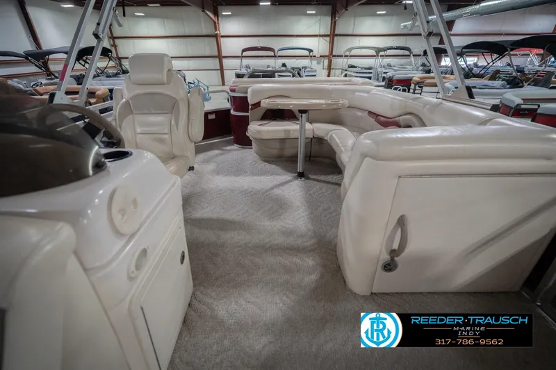 Slide: The Image of 2010 Sylvan 8522 Mirage Cruise interior with plush seating and helm in showroom. - 17