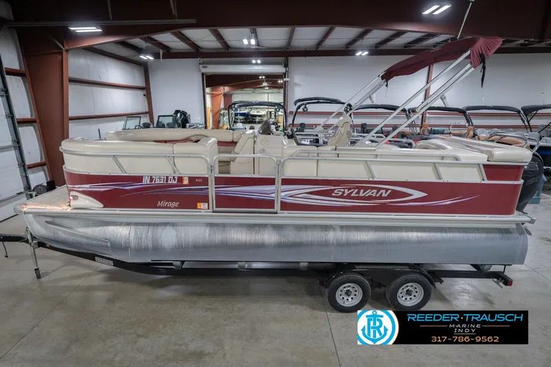 Slide: The Image of 2010 Sylvan 8522 Mirage Cruise pontoon boat in indoor showroom, side view. - 2