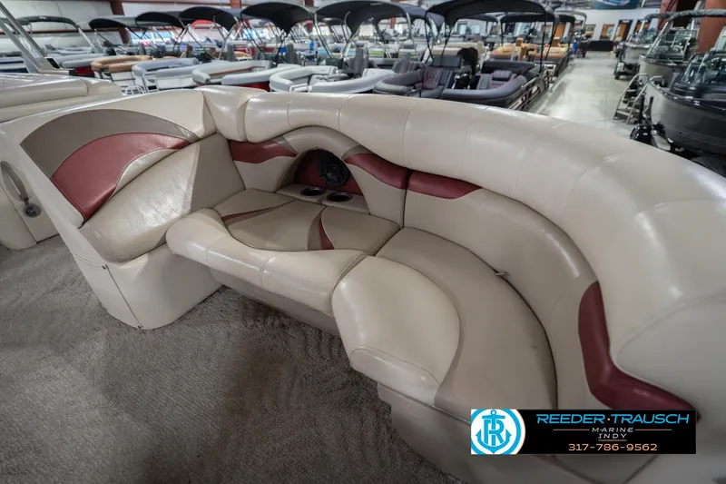 Slide: The Image of 2010 Sylvan 8522 Mirage Cruise boat interior with beige and maroon seating in showroom. - 22