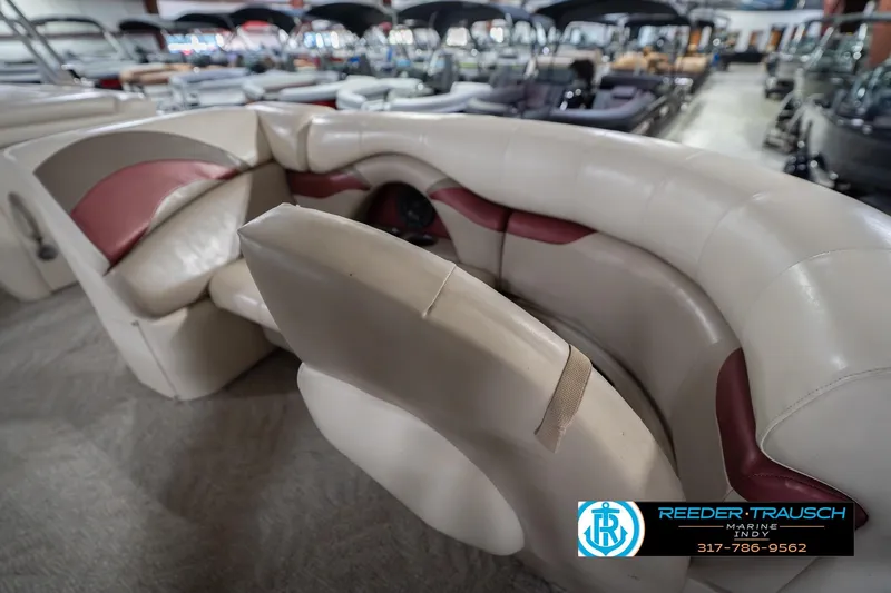 Slide: The Image of 2010 Sylvan 8522 Mirage Cruise boat interior with beige and maroon seating. - 24