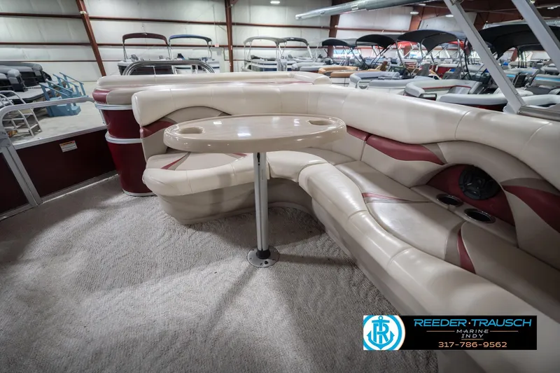 Slide: The Image of 2010 Sylvan 8522 Mirage Cruise interior with plush seating and table in showroom. - 27