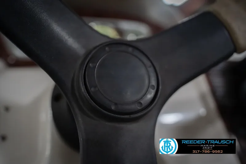 Slide: The Image of Close-up of a 2010 Sylvan 8522 Mirage Cruise steering wheel with Reeder-Trausch Marine logo. - 33