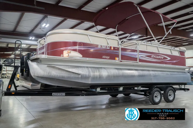 Slide: The Image of 2010 Sylvan 8522 Mirage Cruise pontoon boat on trailer in indoor storage facility. - 4
