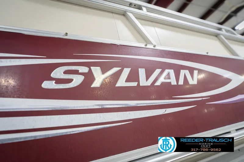 Slide: The Image of 2010 Sylvan 8522 Mirage Cruise boat with maroon and white design. - 54