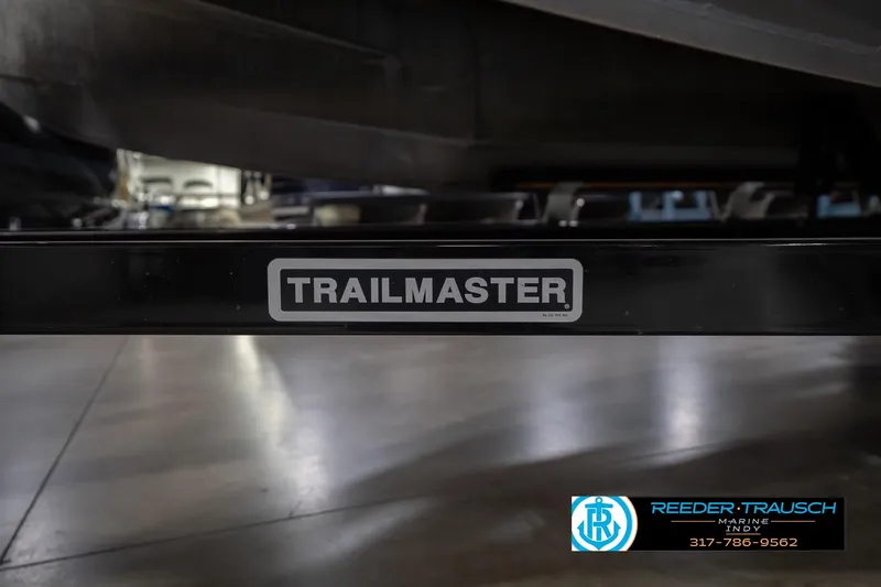 Slide: The Image of 2010 Sylvan 8522 Mirage Cruise on Trailmaster trailer in showroom. - 56