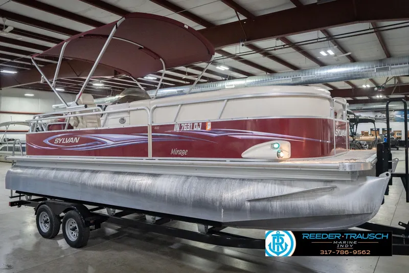 Slide: The Image of 2010 Sylvan 8522 Mirage Cruise pontoon boat in a showroom on a trailer. - 6