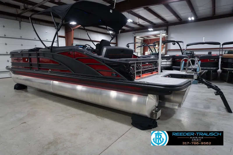 Slide: The Image of 2026 Bennington 25 RSB pontoon boat in showroom, featuring sleek design and modern amenities. - 10