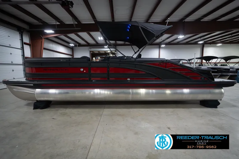 Slide: The Image of 2026 Bennington 25 RSB pontoon boat in showroom, featuring sleek design and modern amenities. - 11